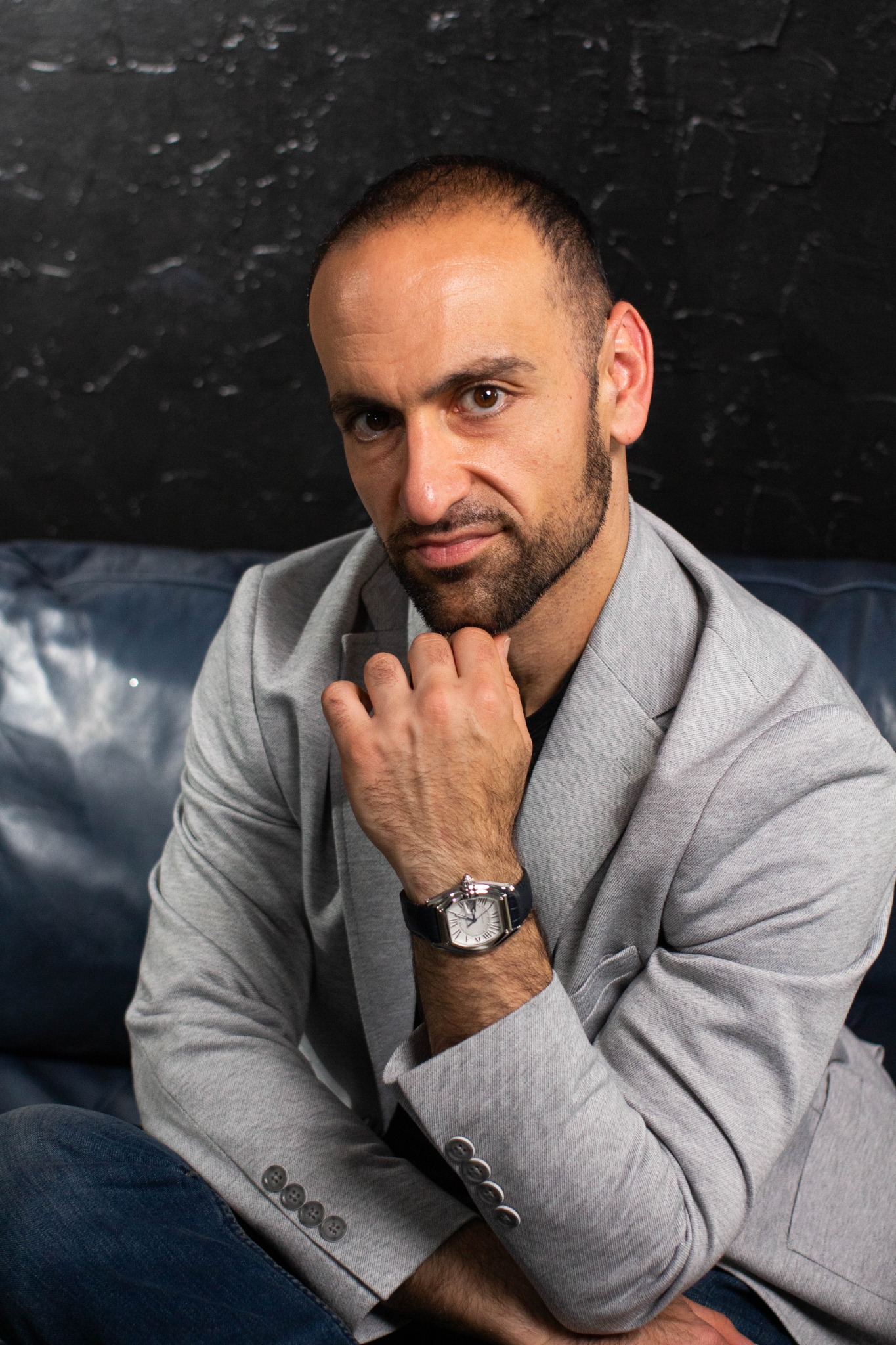 Alex Yarijanian seated in a gray blazer