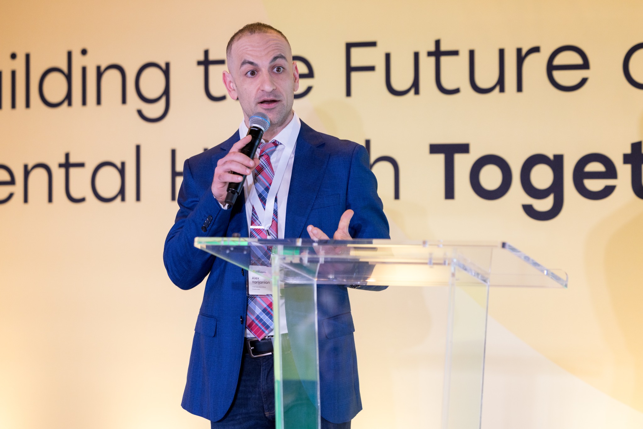 Alex Yarijanian speaking at a healthcare conference