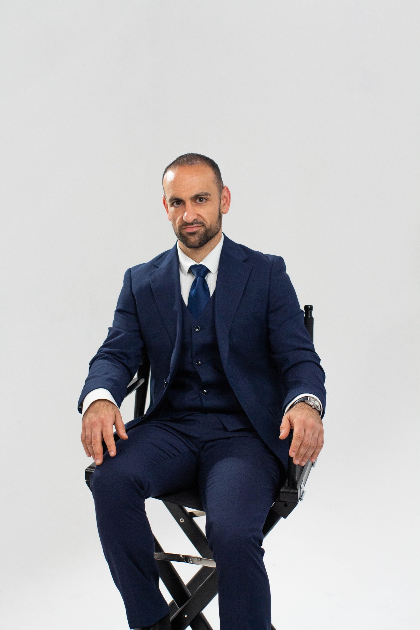 Alex Yarijanian seated in a navy suit